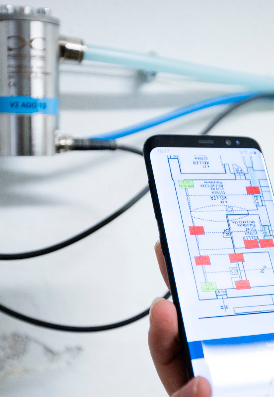 Ein Mitarbeiter von Bogensberger überprüft mit seinem Smartphone die korrekten Einstellungen vor einer Schlauchwaage